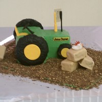 John Deere Grooms Cake Tractor and hay bales were peanut butter cake and tires were rice krispy treats covered in Fondant.