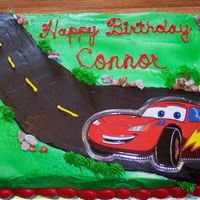 Connor's Cars Cake Done for my friends son, jello cake w/buttercream icing. CAR is actually taken from a t-shirt and mounted on "Press and Seal"...