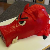 Razorback Hog Carved choc cake out of layers and WM pan stacked on 2" layer. BC layer then covered in MMF. Eyes, ears, tail and tusks are gumpaste...