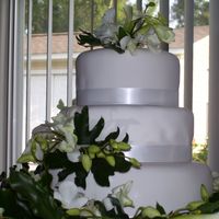 Fondant Covered Wedding Cake Cake I made for a co-worker. My first weddig cake! Top tier is White almond sour cream/almond bc, middle- Pina Colada w/ coconut bc, bottom...