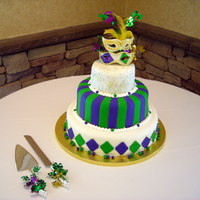Mardi Gras Wedding Cake Mardi Gras themed wedding cake with hand crafted masks made of Fondant.