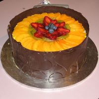 Fruit Flan With Chocolate Collar Sponge fruit flan with chocolate collar made for class. Not too bad for my first collar!! Fruit was also yummy.