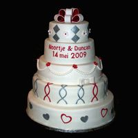 White, Silver And Red Wedding Cake Same colors as the wedding invite and dress.covered and decorated with fondant.