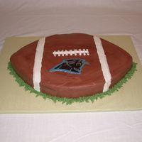 Carolina Panthers Football Cake This was a groom's cake. It's a 12X18 sheet carved into a football with a chocolate transfer for the Panthers logo. The cake was...