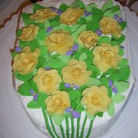 Bouquet For the retirement of the floral designer at Michael's. A Tres Leches cake covered in Coconut Whipped Cream, with fondant decorations...