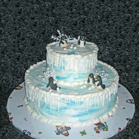 Penguin Winter Cake Snowflakes were royal icing, and the penguins were modeled from fondant. It you look closely, you can see one of the penguins with a...