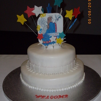 Angels And Stars 12 inch round for bottom, top was 8 inch rouns - Angel and stars are made out of foudant. Lace ban around the 8 inch round with royal icing...