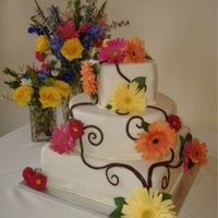 Daisies In Summer 14 inch square red velvet cake with cream cheese icing. 12 in round vanilla cake with raspberry filling. 6 inch square chocolate cake with...
