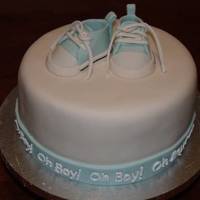 Oh Boy! Simple cake covered in MMF with MMF ribbon. "Oh Boy!" written in royal icing. The little shoes are made with 50/50 gumpaste and...