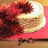 Fall Flower Cake White and chocolate layer cake with chocolate buttercream filling. The flowers on top are fake.