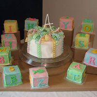 Baby Blocks And Cake This is a baby shower cake that was a fondant creation. It is cherry chip with a middle layer of butter cream mixed with almond extract and...