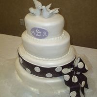 Oval Fondant Wedding Cake This was my first oval wedding cake. I covered it in Satin Ice, and used Super Pearl Luster Dust on it. The bride wanted and eggplant-...