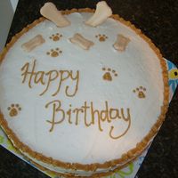Dog Bone & Paw Cake This is an 8" yellow cake with BC frosting. I made the dog bones out of royal frosting. But we ate it..not the dogs!!