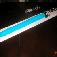 Star Wars Lightsaber I baked 2 13x9 cakes and cut& put them together and shaped them into a lightsaber.