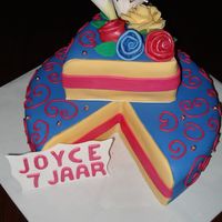 Piece Of Cake Fondant decoration and also a few gumpaste flowers.