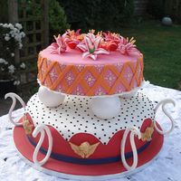 A Colorful Wedding Cake Covered in fondant, gumpaste paisley curls and angels. Royal icing flowers.