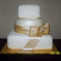 Champagne Color fondant with gumpaste bow and buttercream piping