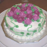 Rose_Cake.jpg My intention was to cover the top of the cake with roses, but my hand started hurting. So, I just centered the roses and added vines to it...