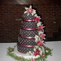 Black Fondant Wedding Cake This was a wedding cake I did for a friend of mines son. It is covered with black fondant, has fondant/gumpaste pearls on the side with...