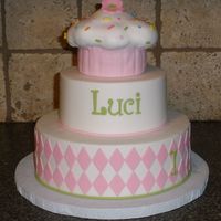 Cupcake Stacked Cake Luci is 1! Made to match the Cupcake invitations. Iced in buttercream with fondant accents. Cupcake is a 4" white cake with cake ball...