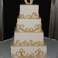 Gold Fondant Scrolls On 4 Tier Square This cake was a pain!! Those scrolls took forever. Thanks for looking.