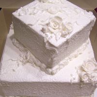 Square Wedding With Swirls And Roses The bride and groom are adding the topper - it will be an "M" monogram. The cake is 12" bottom/7" top- french vanilla...