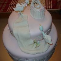 Nicole's Baby Shower This is a cake that I made for my niece. Vainilla cake 12" and 10" Decoration are made from gumpaste