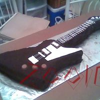 Gibson Explorer Guitar cake my best friend and I made for her son's 16th birthday party. Covering is crushed Oreos. Neck had Ghirardelli chocolate...