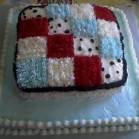 Baby Blanket Buttercream frosting made to match baby blanket. Red, baby blue, white and dalmation print.