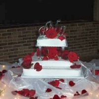 Wedding Cake This is a red velvelt cake with buttercream icing. Decorated with real roses & topped with momograms.