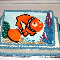 Nemo A canvas of pastillage displayes Nemo surrounded by coral, kelp, sand & shells. The canvas is proped on a 1/4 sheet cake. Too much blue...