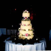 Wedding Cake Rum Pound Cake with Ivory colored Buttercream iceing. Top tier held up with four crystal sherry glasses. Fresh flowers placed on each tier...