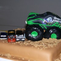 Grave Digger I used fondant icing and Rice Krispie Treat tires. Grave Digger was carved from a 9x13 with lots of extra cake left over. Yum.