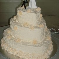Cold Feet Heart Shaped wedding cake with butter cream icing. Simple design...Royal Icing flowers. Gotta love the topper :)