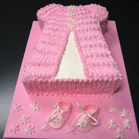 Baby Dress And Booties Cake is buttercream, booties are fondant