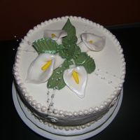Cala Lily 9" Chocolate cake with buttercream. Cala lilies made from fondant. My first time using luster dust and I love it!