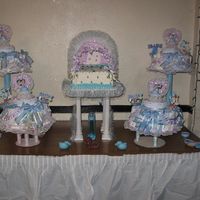 Stroller Cake With Diaper Cakes This is a Stroller cake for a boy with diaper cakes surrounding it. I made this cake for one of my customer along with the diaper cakes...