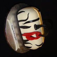 Zebra Birthday Red velvet cake. Covered in buttercream and MMF. Handles are gumpaste. Scarf is fondant.