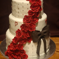 Black Magic Roses Wedding Cake 12", 10", 8" chocolate banana cakes with strawberry buttercream filling. The roses are 50/50 mix. The bride wanted black...