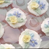 Spring Flowers Cupcakes A rose, drop daisey, and somthing trying to resemble a rose bud piped atop cupcakes in buttercream.