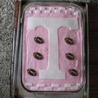 Ut Girl Cake Strawberry cake with strawberry icing, the "T" and the checker board design at the top and bottom made from white fondant, the...