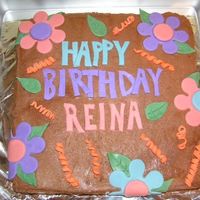 Birthday Cake Homemade chocolate cake with buttercream chocolate icing. Flowers, streamer decor, and letters are fondant colored with gel food colorings...