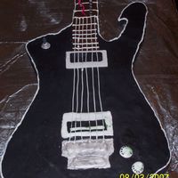 Another View Of My First Cake Here's another view. Its an exact replica of my fiancee's guitar for his birthday. Any tips?