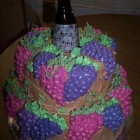 Wine Party Cake Chocolate Buttercream w/ Amaretto buttercream grapes. Unfortunately the good wine bottle broke and I had to use the crappy one.