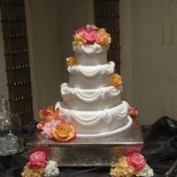 White Hexagon With Sidework Bride chose white hexagon with scroll sidework, fondant drapes and silk flowers.