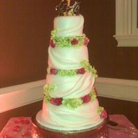 Hydrangeas And Roses Tiered with green hydrangeas and coral roses
