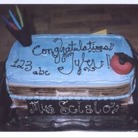 School Desk Cake This cake was great fun too make. It has crayons, an apple with a worm in it, and on the back a piece of homework that the dog ate! It was...