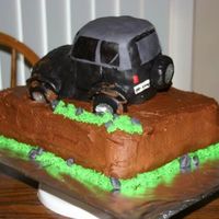 Jeep Grooms cake. Jeep is made fro rice krispy treats and covered in fondant. Cake is all chocolate