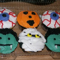 Halloween Cupcakes Cupcakes for a cake walk. 1/2 of cupcakes were triple chocolate, other 1/2 were yellow cake with a kiss inside. All frosted in bc.