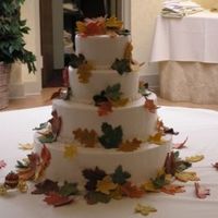 Autumn Leaves White cake frosted in vanilla buttercream with candy clay cut - out leaves, hand paninted and strategically placed...falling over cake.